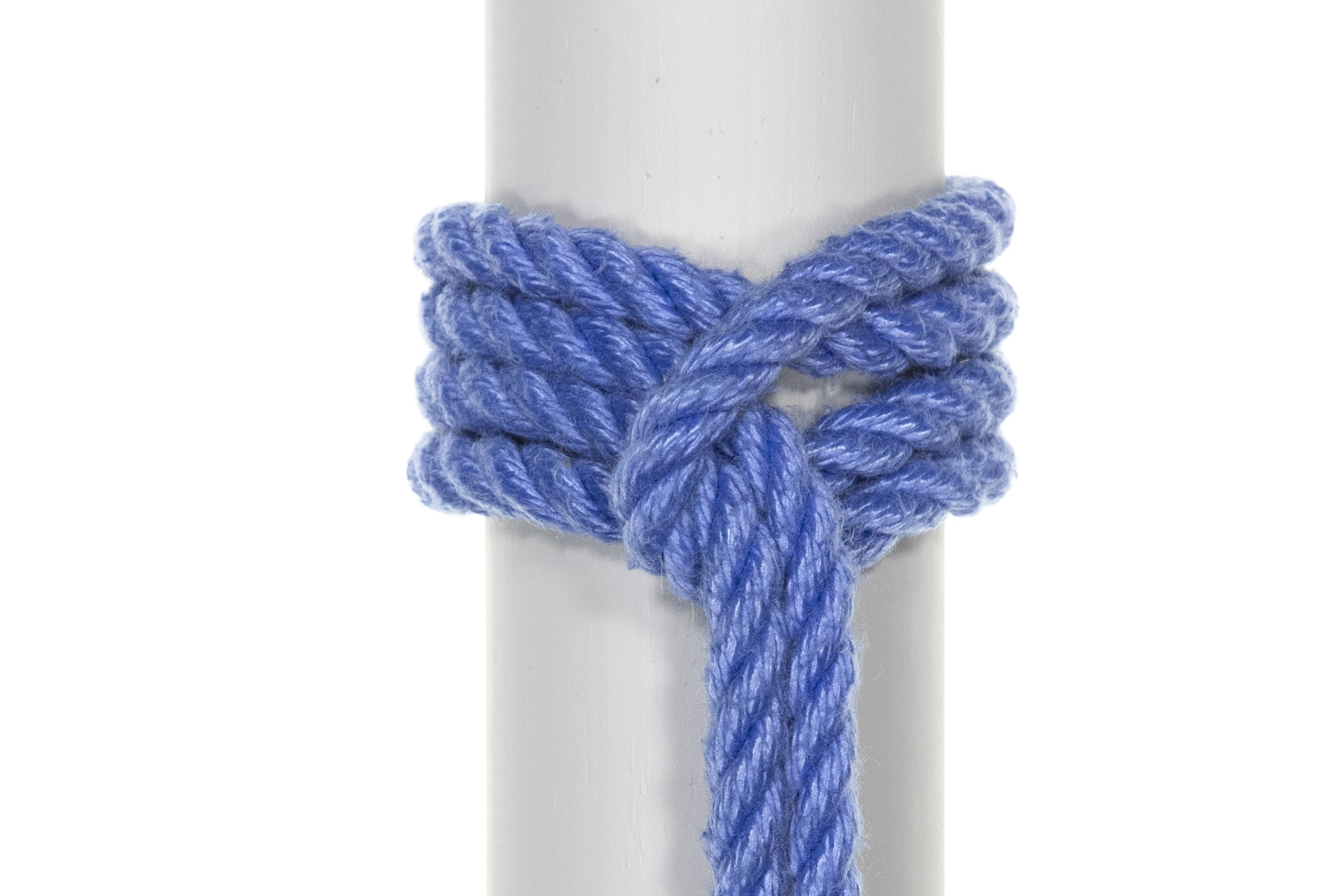 A completed Prusik knot around a three inch diameter vertical gray pole. Four strands of rope circle the pole snugly, held in place by the bight. The whole configuration looks like a lark’s head with an extra pass of rope through the middle of it. The standing part of the rope comes out of the bight and hangs vertically below the knot.