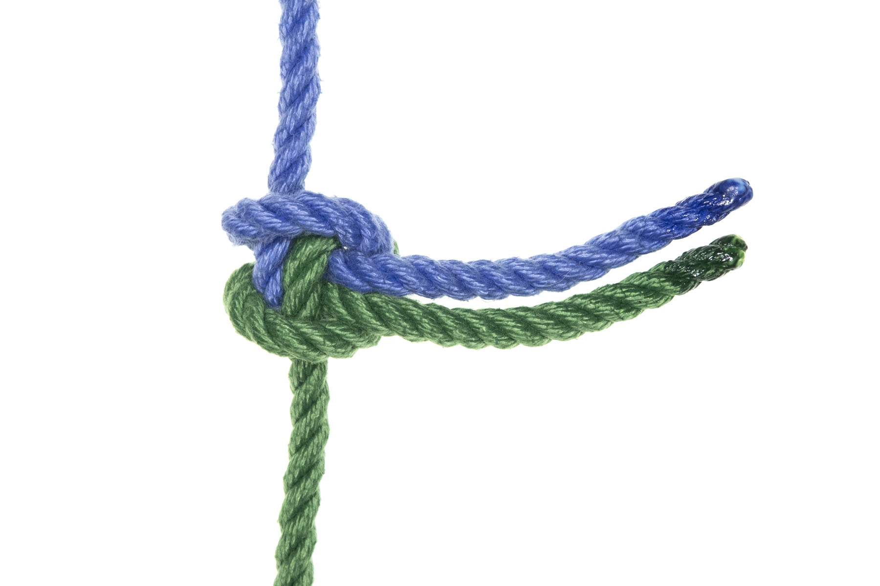 A completed alpine butterfly bed. A single blue rope entering from the top meets a single green rope entering from the bottom. They form a knot, and three inches of each rope stick out of the knot to the right. The tail of the blue rope is next to the tail of the green rope and slightly higher than it.