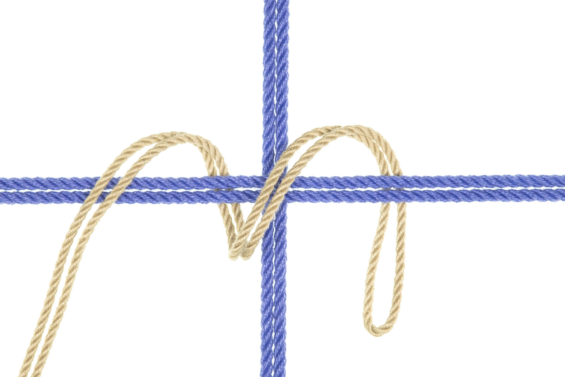 The tan rope crosses under the horizontal blue rope, from the NE quadrant into the SE quadrant.