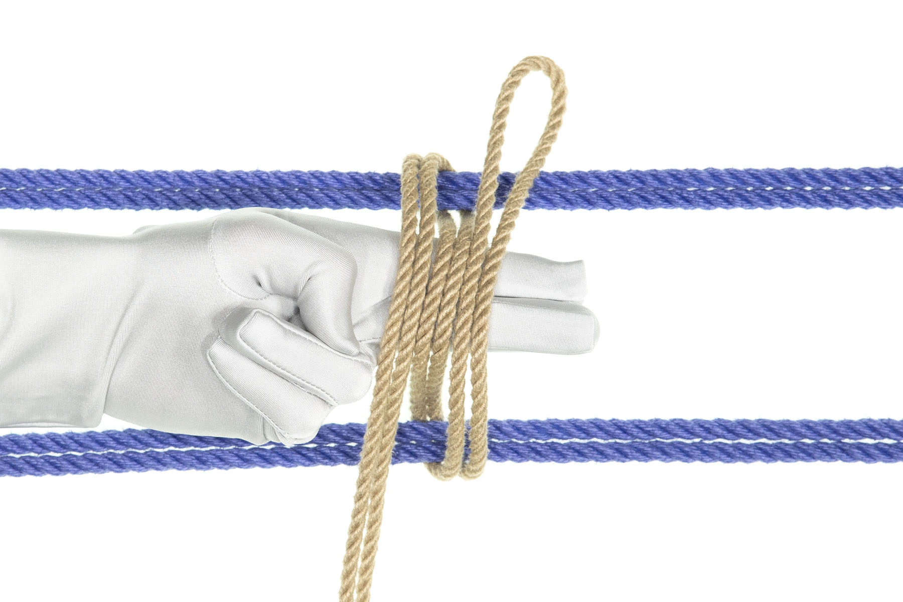 The bight of the tan rope has been laid over the index and middle fingers, next to the other two passes of the tan rope. All three passes of the tan rope have been slid together, making three parallel passes that lie on top of the fingers.