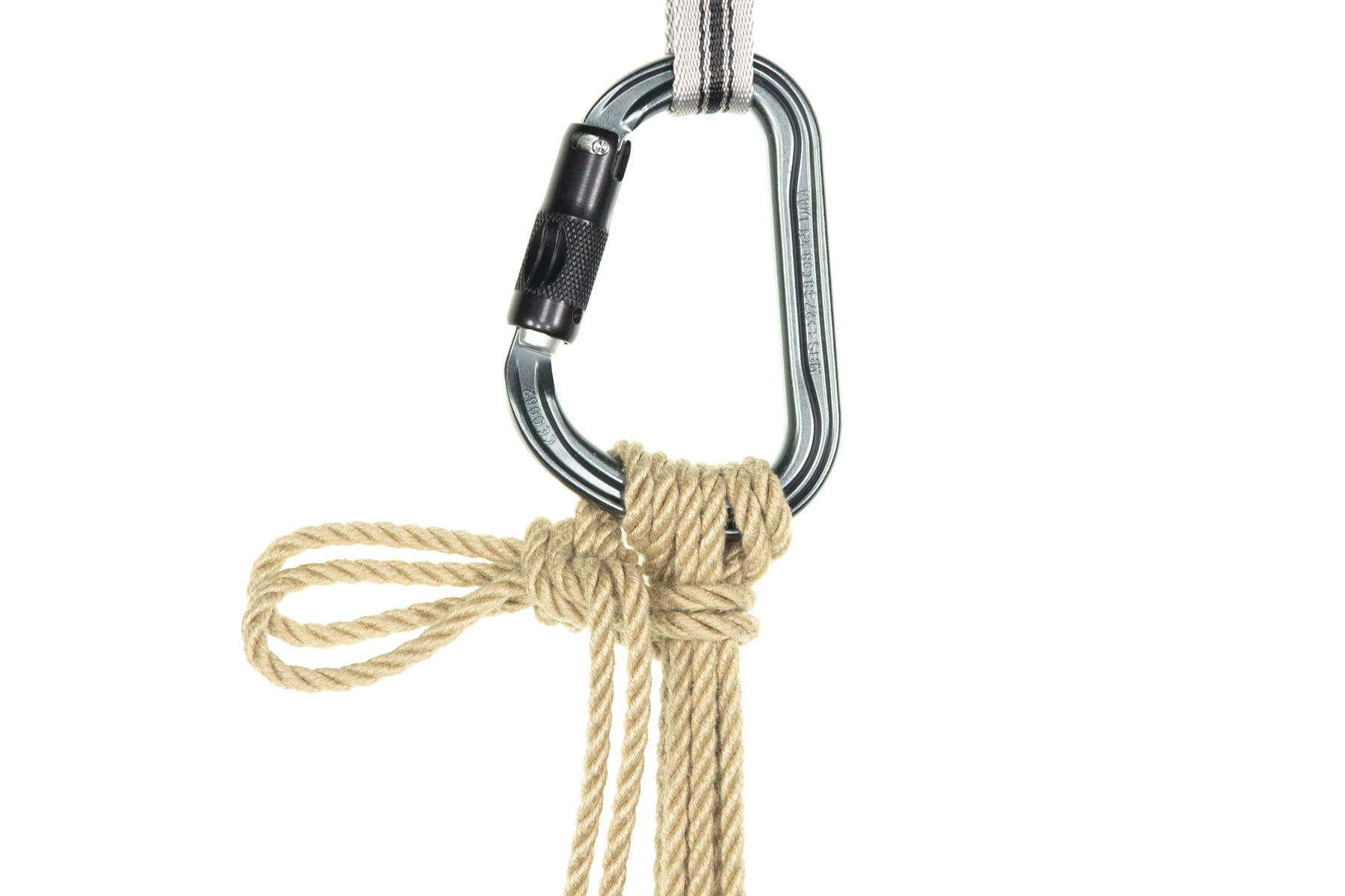 The loop has been pulled snug, forming a yuki knot over the bight of the slipped half hitch. The working end of the rope hangs down just to the left of the vertical lines.